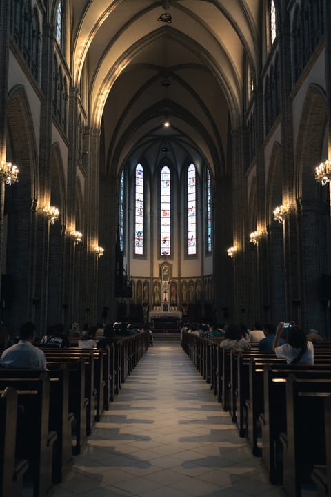A cathedral interior with high arches and stained glass