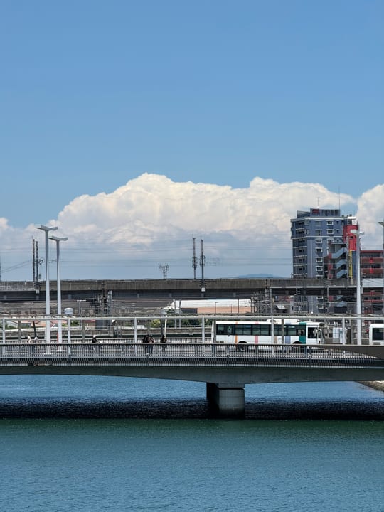 White clouds above urban bridges and buildings